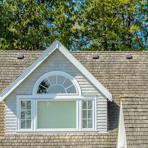 Three static roof vents installed near the upper edge of a residential roof.