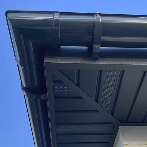 Perforated soffit ventilation panels beneath a residential roof overhang.